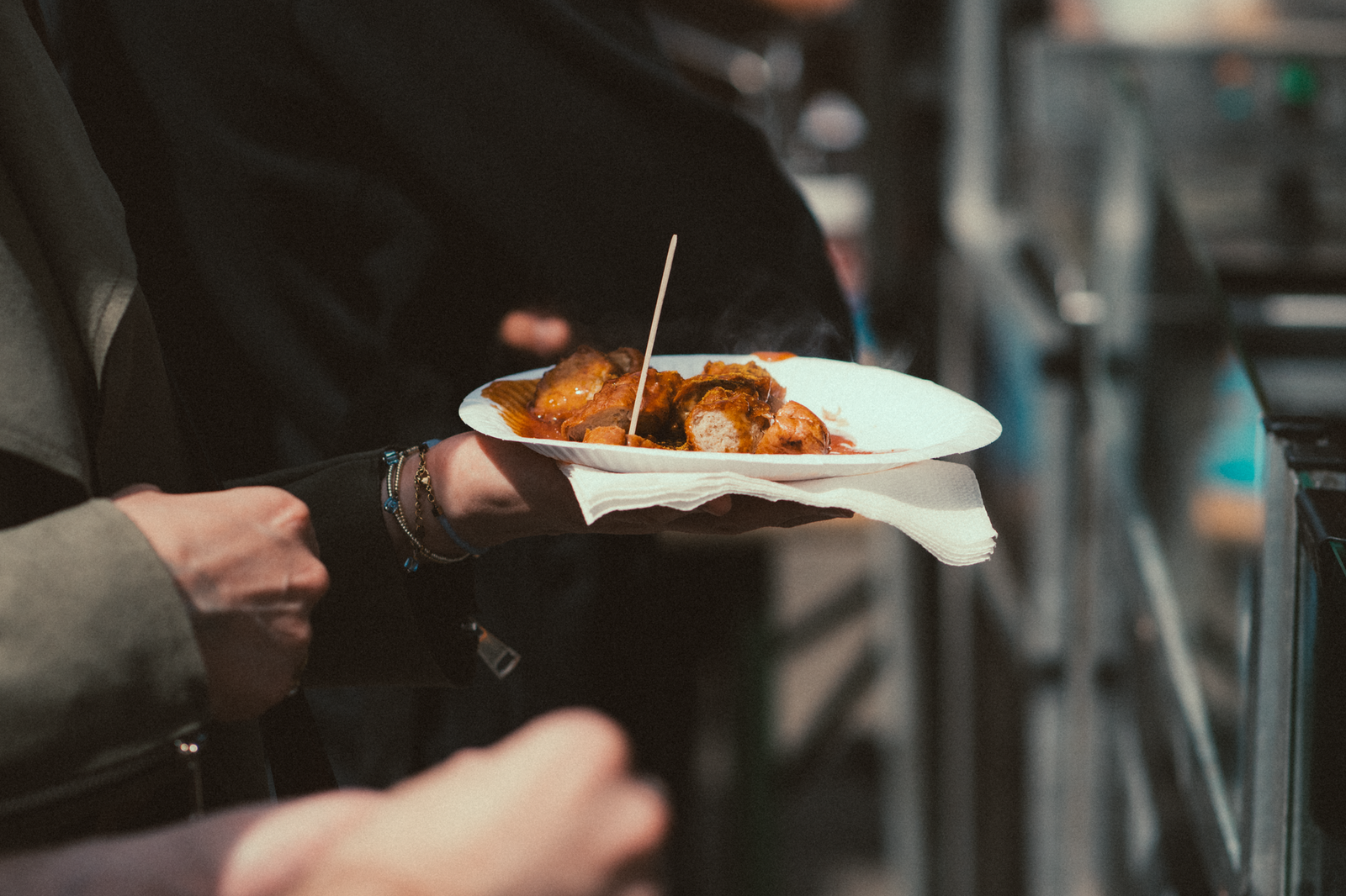 Person Holding Plate with Street Food